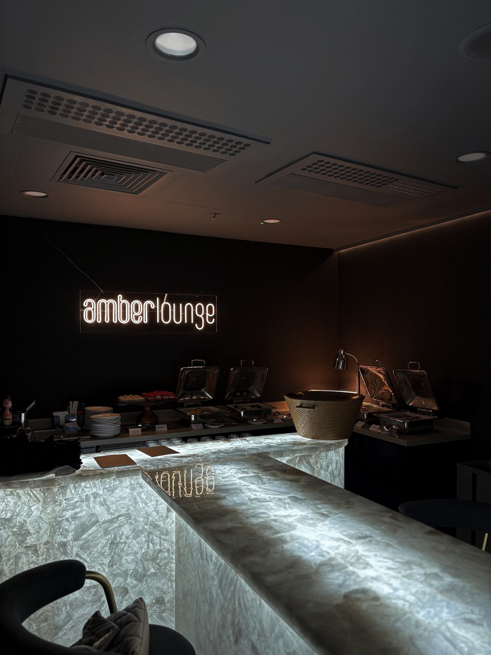 Private marble bar with illuminated Amber Lounge signage